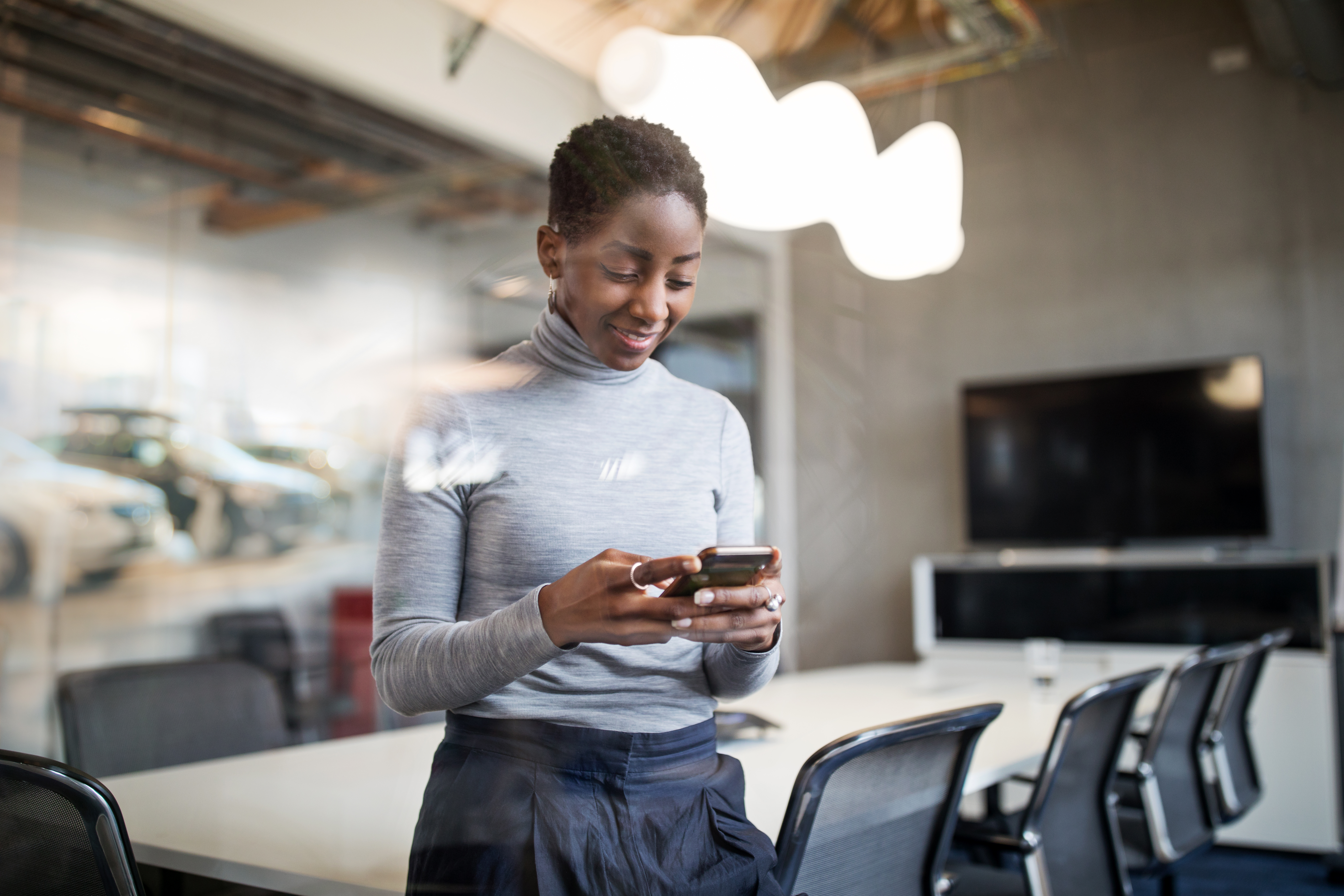 Business woman using cellphone in office