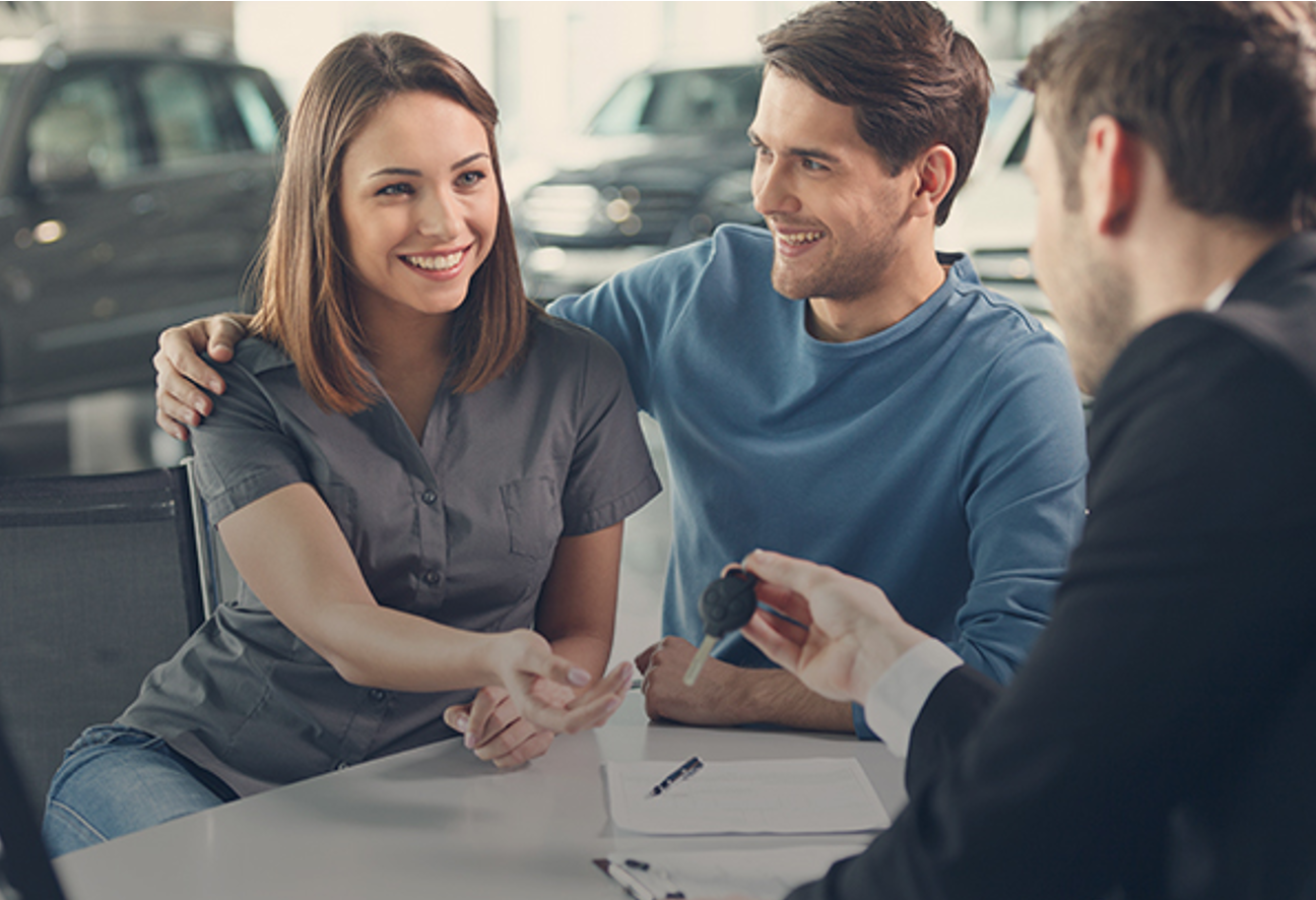 Couple taking keys at dealership