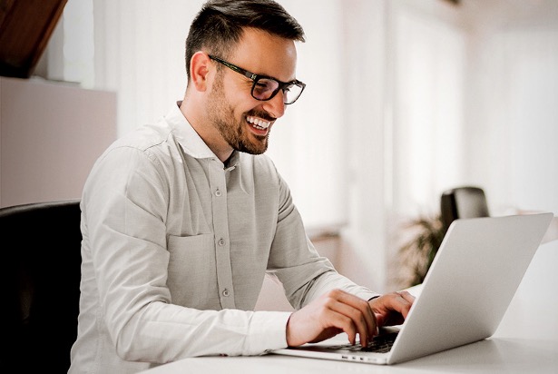 Man with glasses at laptop
